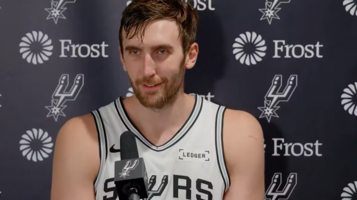 San Antonio Spurs player smiling confidently during playoffs.