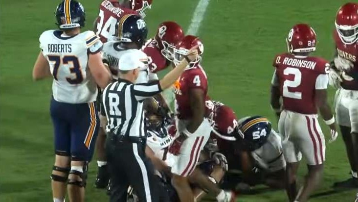 SEC Football Defensive Plays: Excited players celebrate in a game.