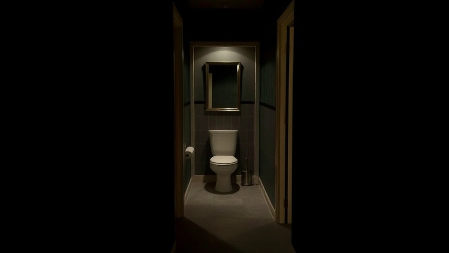 Dark hallway leading to bathroom, promoting mental wellness for seniors through restful sleep.