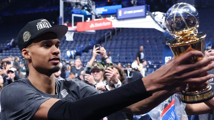 Young athlete spinning basketball indoors, related to San Antonio Spurs news.