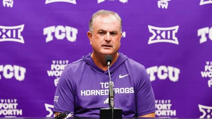 TCU penalty problems represented by focused coach and players with stadium backdrop.
