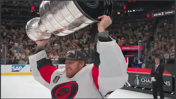 Hockey player celebrating Stanley Cup Champions victory.