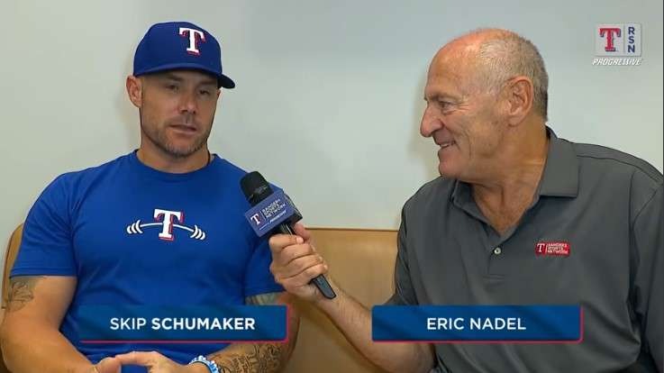 Casual interview scene with two men discussing team strategies.