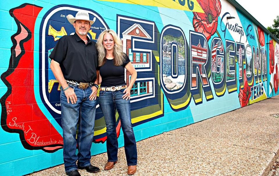 Schoepf's BBQ Georgetown mural with two smiling people.