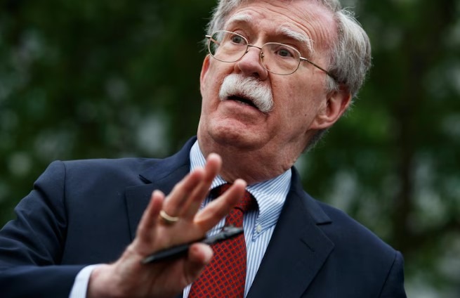 Elderly man waving outside, FBI investigations context, lush greenery background.