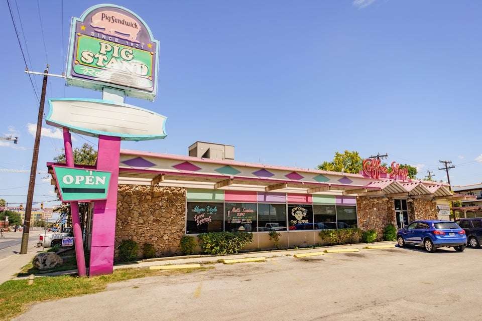 Retro diner in San Antonio with vintage style and parked cars.