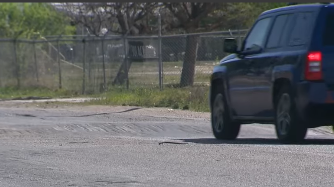 San Antonio news scene with pickup truck on dimly lit road.