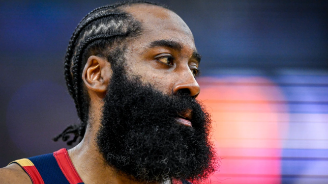 Basketball player in focus looking upwards on the court.