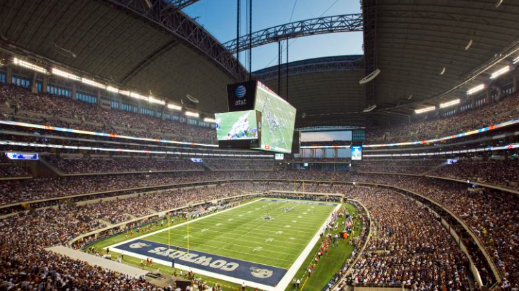 Inside Dallas Cowboys stadium showing team branding.