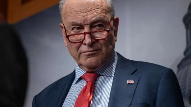 Government shutdown news: focused speaker addressing audience.