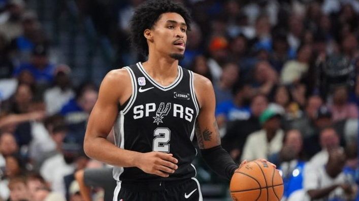 Dylan Harper playoffs preparation, basketball player focused in arena.