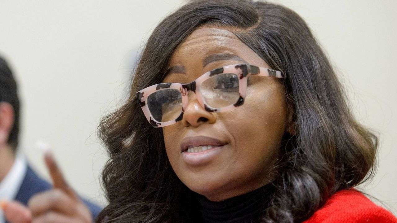 Woman speaking at Texas politics event with microphone.