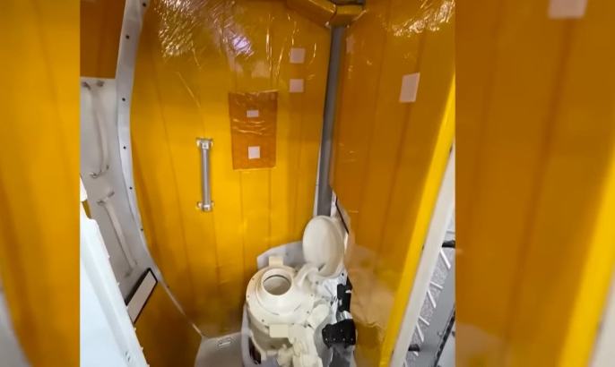 Man smiling in a formal suit, cityscape backdrop.