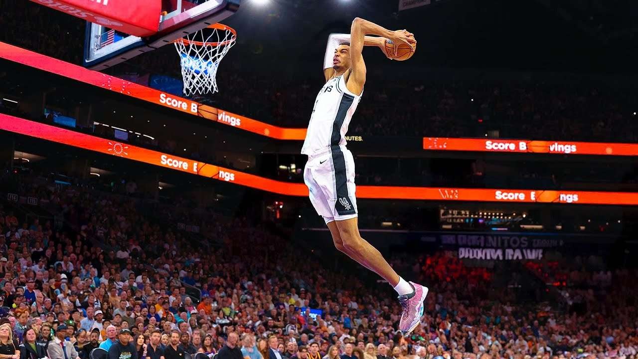 Intense basketball action, player shooting amidst cheering fans, Houston sports news.