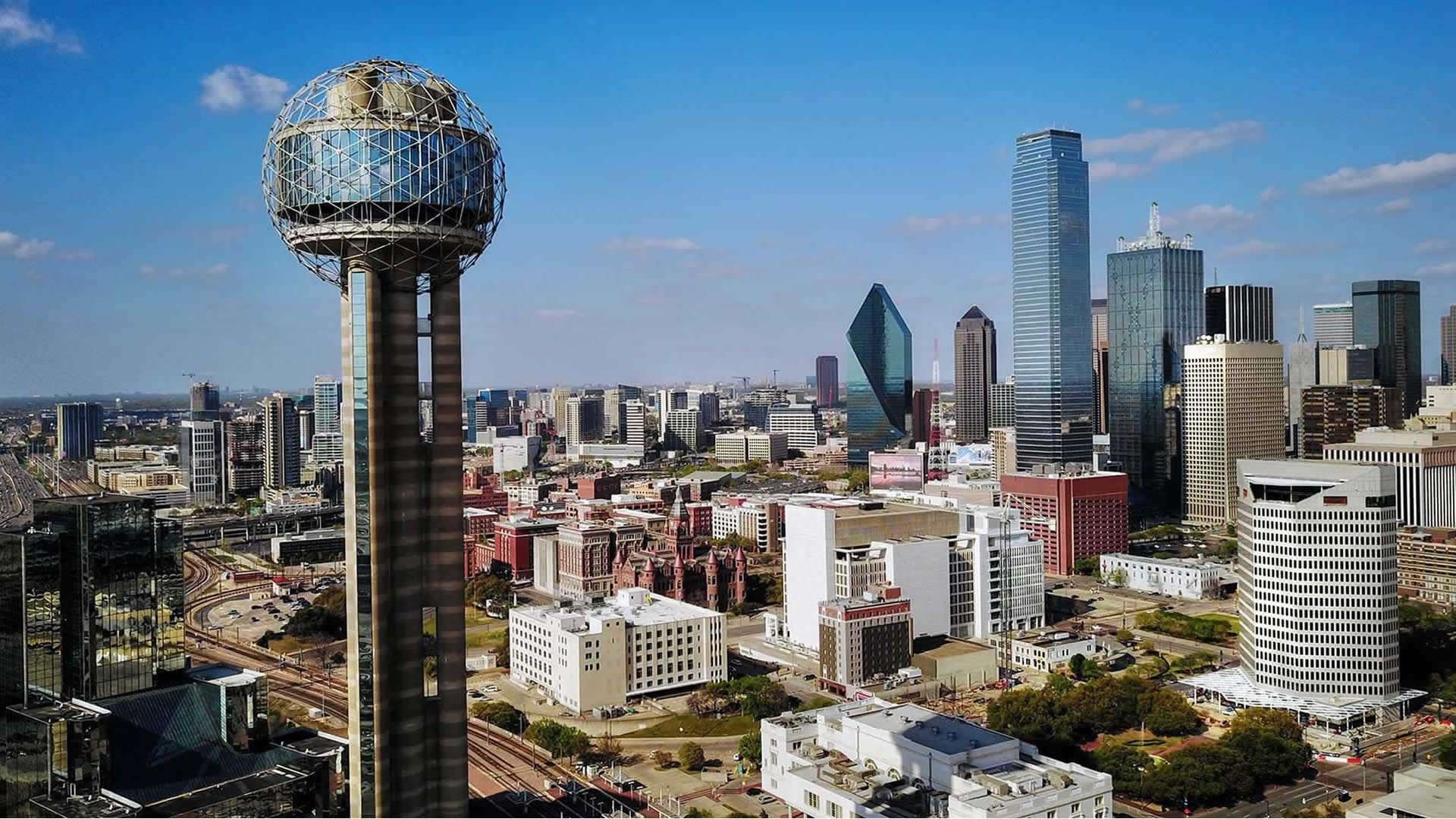 Dallas cityscape with skyscrapers and highways, Dallas-Fort Worth real estate market focus.