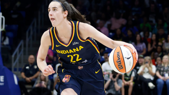 WNBA player dribbling during a game, highlighting WNBA viewership increase.