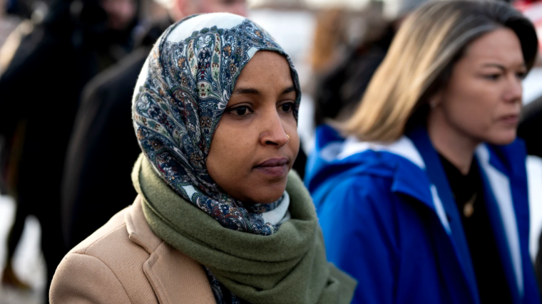 Ilhan Omar at public event, smiling with man and speaking at podium; financial disclosures context.