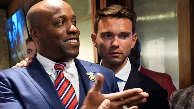 Confident individuals discussing in a warmly lit room, Texas Senate race hotel expenses.