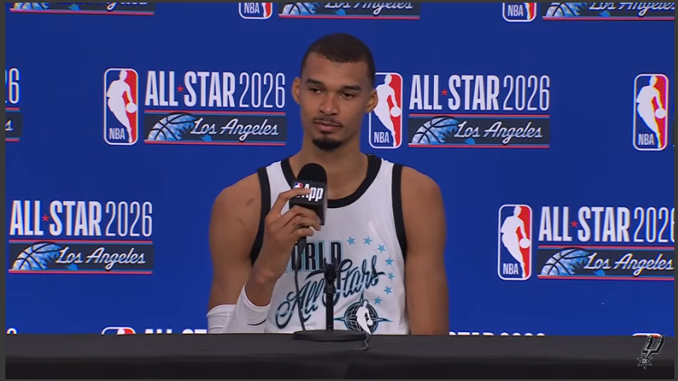 Competitive NBA All-Star Game with enthusiastic player holding mic.