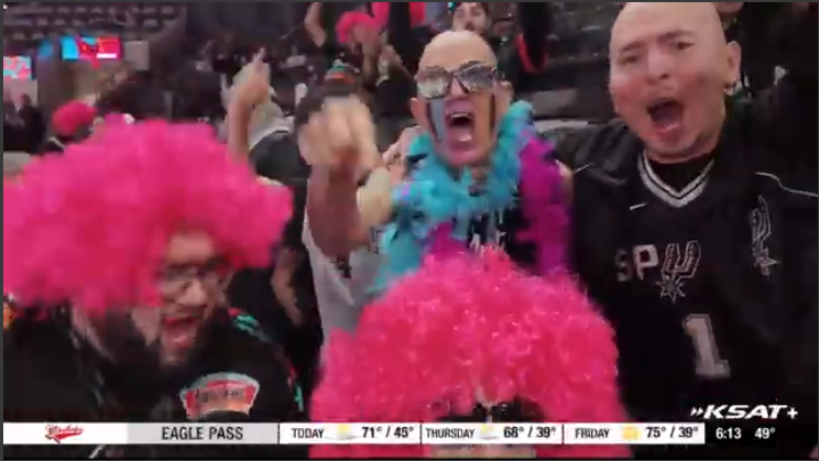 San Antonio Spurs fans cheering energetically on stadium screen.
