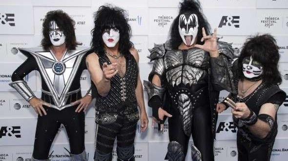 Iconic KISS-inspired group in full costume, media backdrop