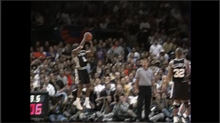 Dynamic action shot capturing 1999 NBA Finals highlights dunk.