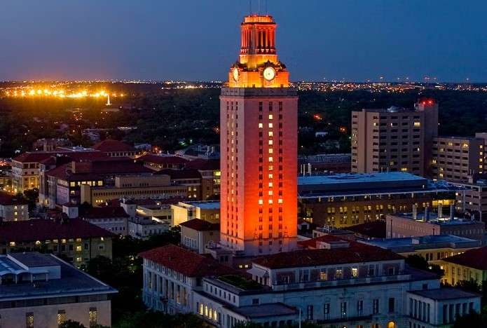 Aerial view of a bustling college town in America with a historic clock tower.