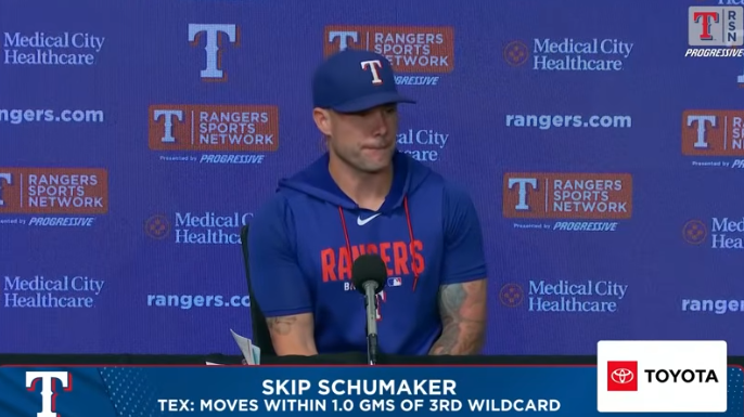 Focused athlete giving postgame interview insights, seated at a table.