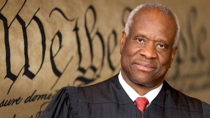 Clarence Thomas story discussion on news set with middle-aged man.