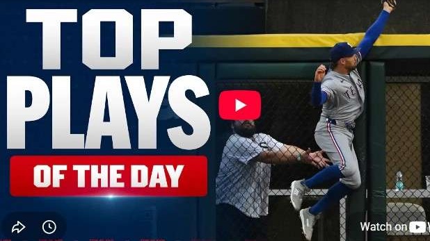 MLB Highlights: player catches ball at fence in action shot.