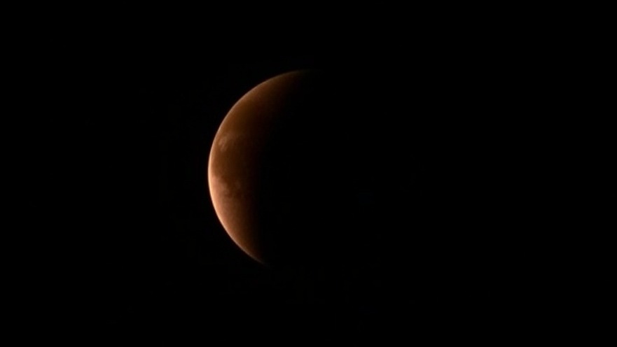Dramatic lunar eclipse over San Antonio, highlighting the stunning night sky.
