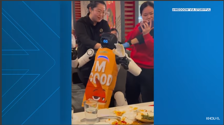 Dancing robot restaurant incident with robot waiter in action.