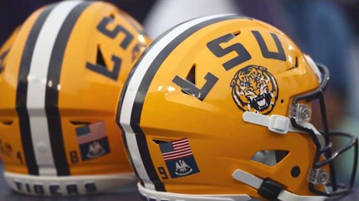 Close-up of bright yellow LSU football helmets with logos.