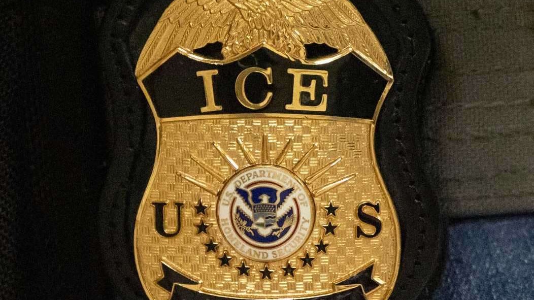 San Antonio news: ICE officer badge close-up on uniform.