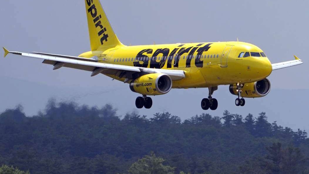 Spirit Airlines shutdown announcement on digital display about refunds.