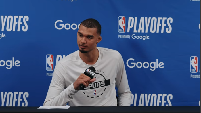Basketball player speaks on Spurs game, showcasing determination.